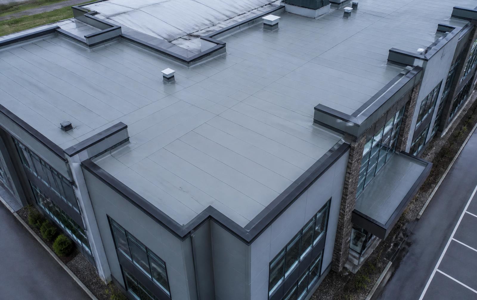Drone stand-off view of a commercial building roof, parapets and façade
